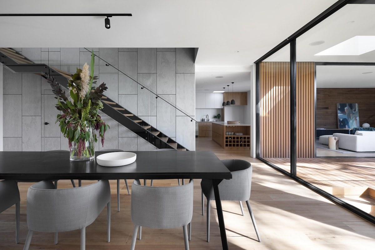 Natural wood flooring connecting an open-plan living and dining space
